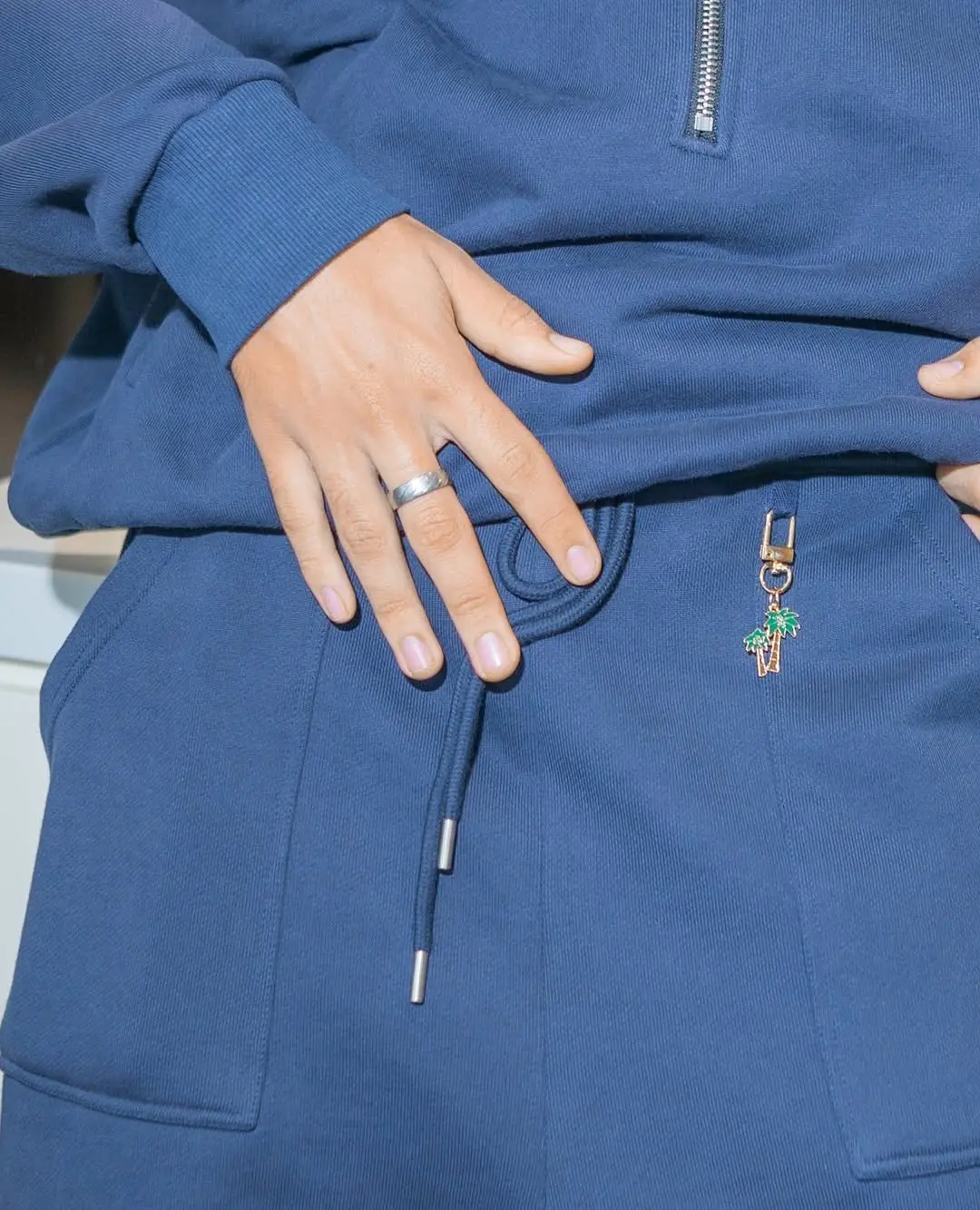 Cobalt blue half-zip sweatshirt and joggers with a palm zipper pull